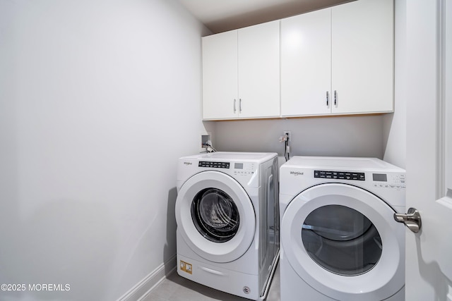 washroom featuring washing machine and dryer and cabinets