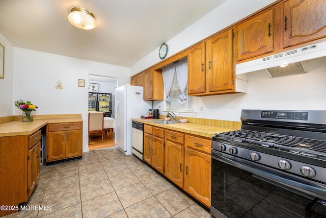 kitchen featuring light tile patterned flooring, stainless steel appliances, and sink