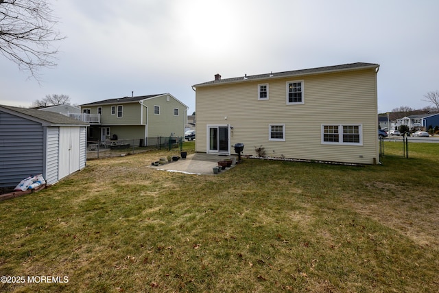 back of property featuring a patio area, a storage shed, and a lawn