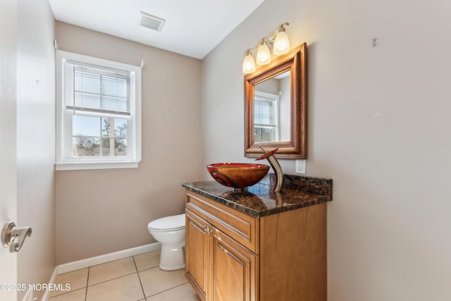 bathroom with baseboards, visible vents, toilet, tile patterned floors, and vanity