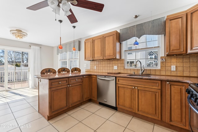 kitchen featuring stainless steel appliances, brown cabinets, and a sink