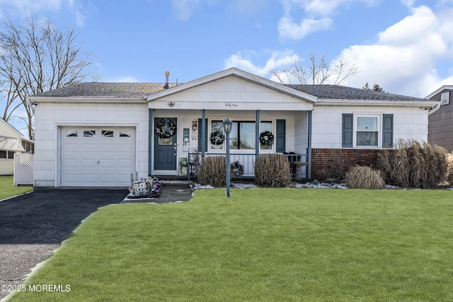 single story home featuring a garage, covered porch, and a front yard