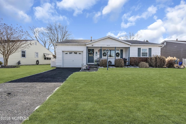 ranch-style home featuring a front lawn, covered porch, and a garage