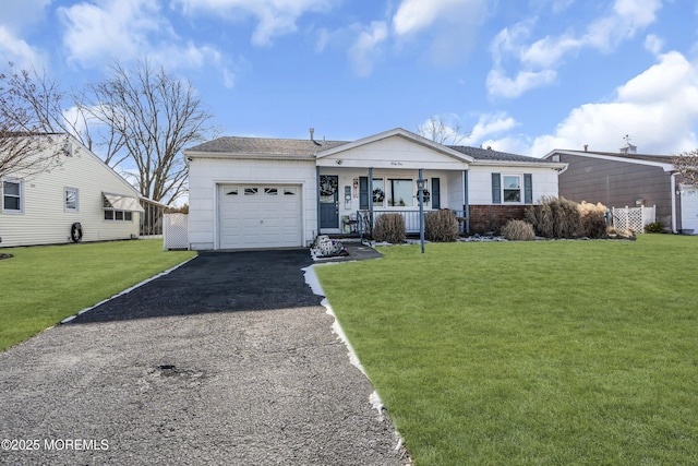 single story home featuring a front yard, a porch, and a garage