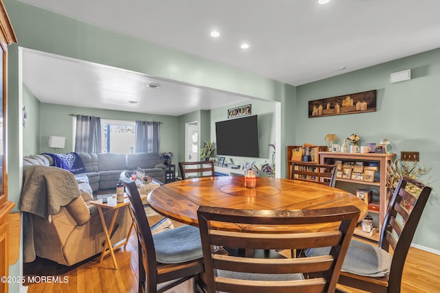 dining space with light hardwood / wood-style floors