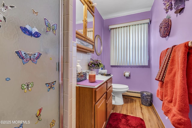 bathroom featuring a baseboard radiator, wood-type flooring, toilet, a shower with door, and vanity