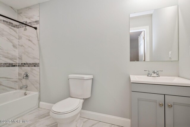 full bathroom with vanity, tiled shower / bath combo, and toilet