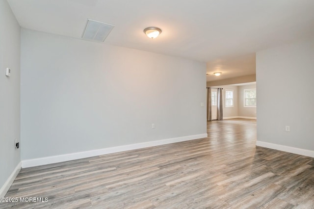 empty room with light hardwood / wood-style flooring