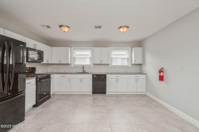 kitchen featuring black appliances, white cabinets, sink, decorative backsplash, and light stone countertops