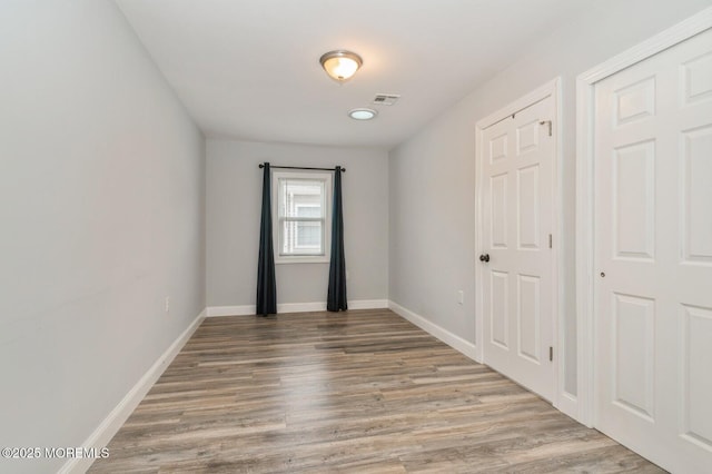 spare room with hardwood / wood-style flooring