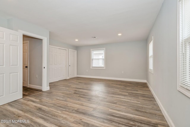 unfurnished bedroom with hardwood / wood-style flooring