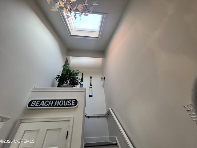 staircase featuring a skylight