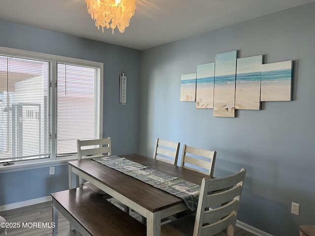 dining space with a notable chandelier and hardwood / wood-style floors