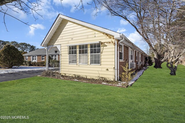 view of home's exterior with a yard