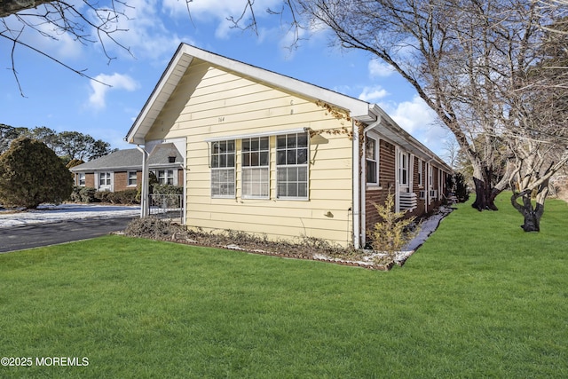 view of property exterior with a lawn