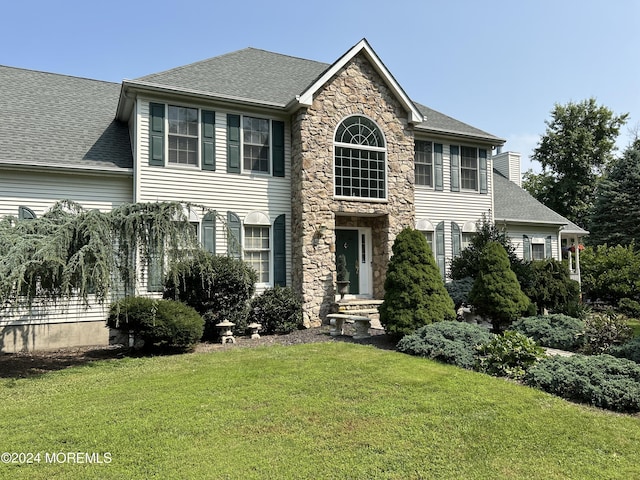 colonial-style house with a front yard