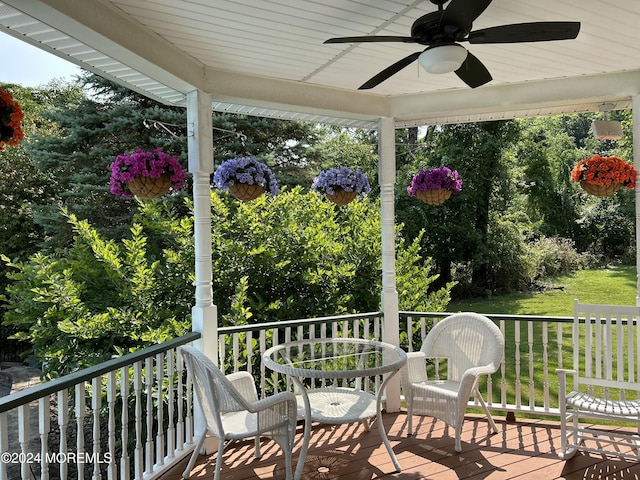 deck with ceiling fan and a yard