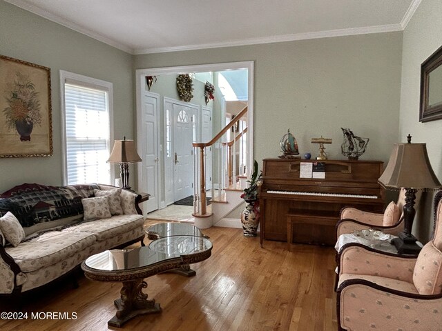 living room with light hardwood / wood-style floors and crown molding