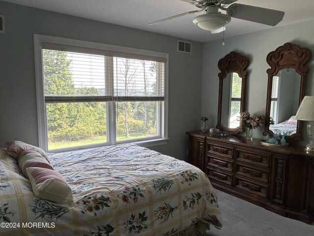 carpeted bedroom featuring ceiling fan