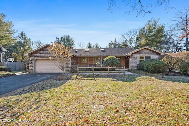 single story home with a garage and a front lawn