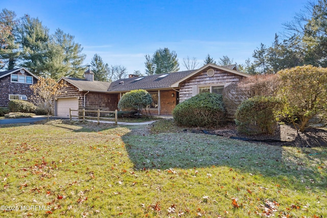 view of front of property with a front yard and a garage