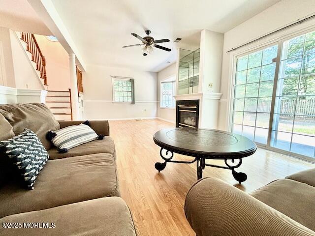 living room featuring light hardwood / wood-style floors and ceiling fan