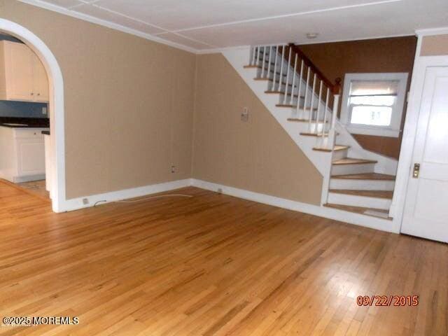 unfurnished living room with hardwood / wood-style flooring