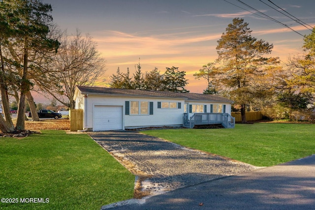 view of front facade featuring a lawn and a garage