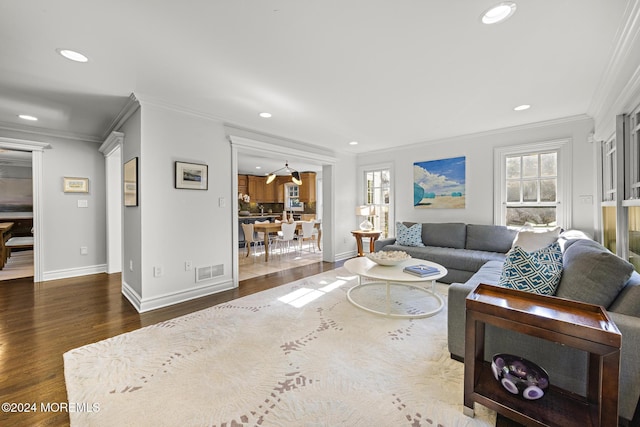 living room with dark hardwood / wood-style floors and ornamental molding