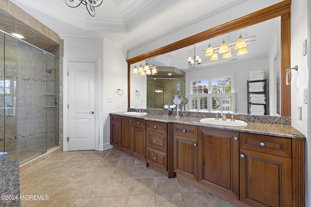 bathroom with crown molding, vanity, a chandelier, and walk in shower