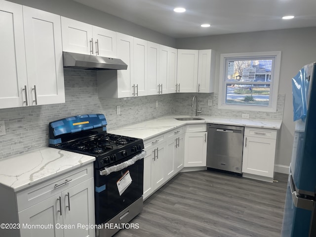 kitchen featuring dark wood-type flooring, white cabinetry, sink, and stainless steel appliances