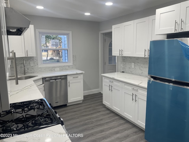 kitchen featuring sink, dark hardwood / wood-style floors, appliances with stainless steel finishes, light stone counters, and white cabinetry