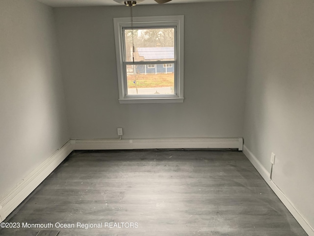 empty room with baseboard heating and ceiling fan