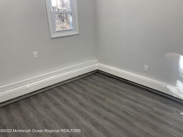 unfurnished room with dark wood-type flooring