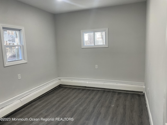 unfurnished room featuring dark hardwood / wood-style flooring