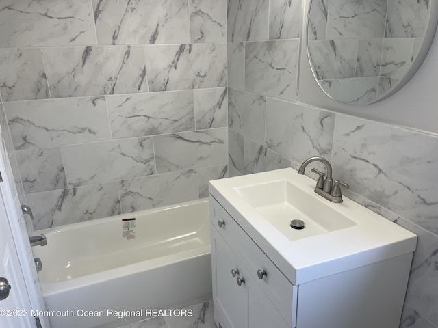 bathroom featuring vanity, decorative backsplash, and tile walls