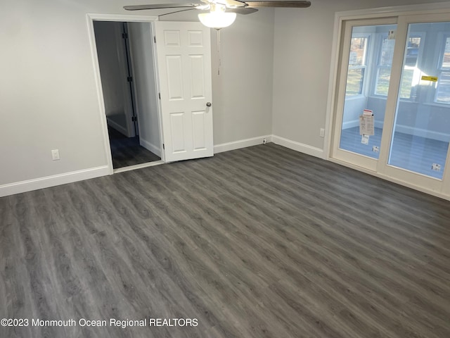 unfurnished room featuring ceiling fan and dark hardwood / wood-style flooring