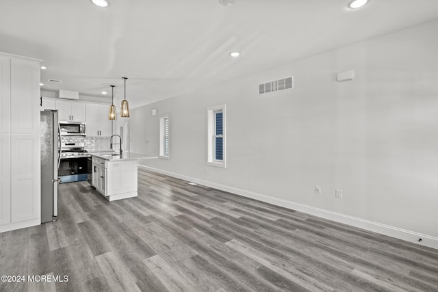 unfurnished living room with sink and light hardwood / wood-style flooring