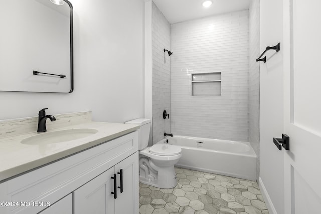 full bathroom featuring toilet, tiled shower / bath combo, and vanity