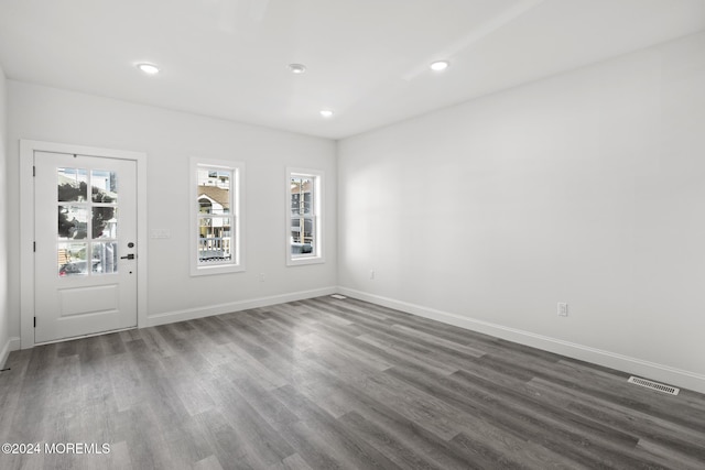 empty room with dark hardwood / wood-style flooring