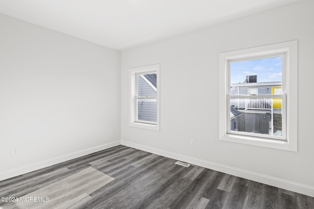 spare room featuring dark hardwood / wood-style floors