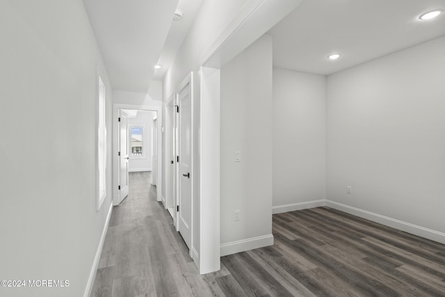 hallway with dark hardwood / wood-style flooring