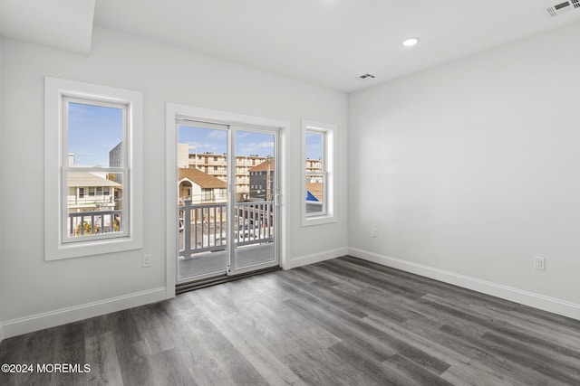 spare room with dark hardwood / wood-style flooring