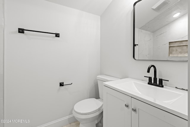 bathroom featuring toilet and vanity