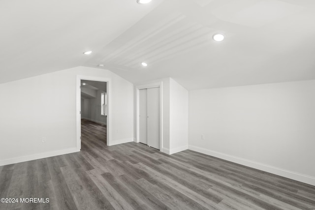 bonus room featuring dark hardwood / wood-style flooring and vaulted ceiling