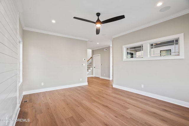 unfurnished room with plenty of natural light, light wood-type flooring, and ornamental molding