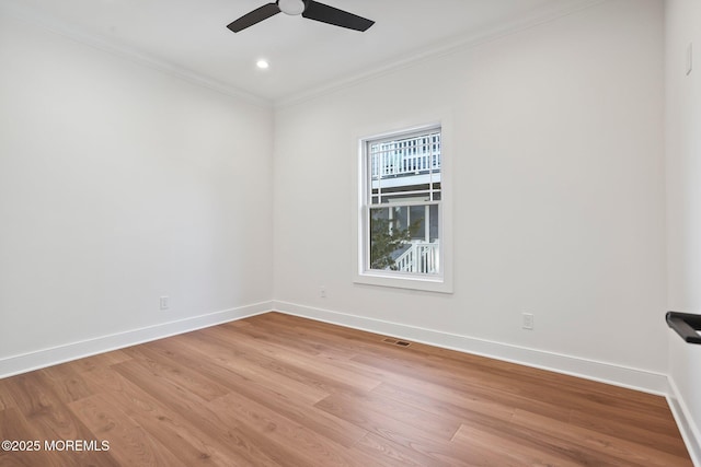 spare room with crown molding, ceiling fan, and light hardwood / wood-style floors