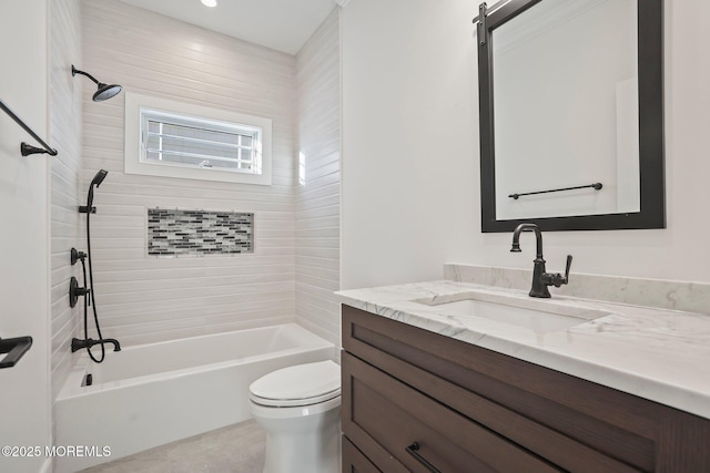 full bathroom with vanity, tiled shower / bath combo, and toilet