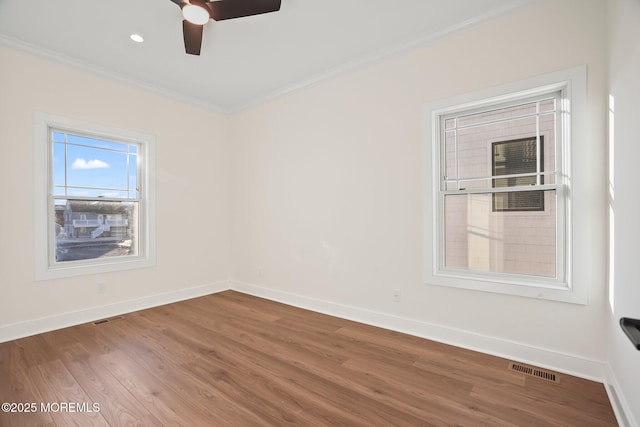 spare room with hardwood / wood-style floors, ceiling fan, and ornamental molding