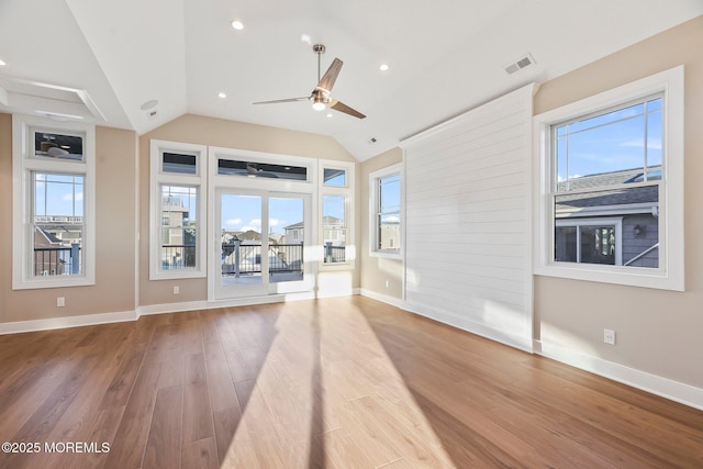 unfurnished living room with ceiling fan, vaulted ceiling, and hardwood / wood-style flooring